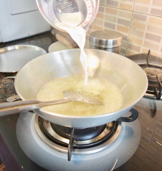 दूध डालिये उबलते पानी में pouring milk into boiling water